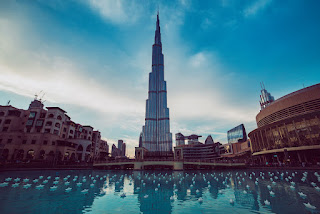 burj khalifa dubai uae tallest skyscraper building world travel attraction with blue pool foreground - Skyscrapers in Dubai